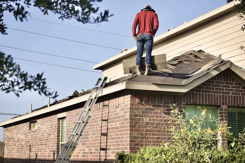 Professional roofer working on a residential roof in Converse